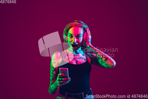 Image of Portrait of young caucasian woman on purple background with copyspace, unusual and freaky appearance