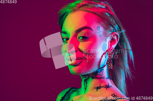 Image of Portrait of young caucasian woman on purple background with copyspace, unusual and freaky appearance