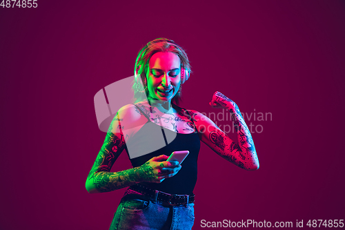 Image of Portrait of young caucasian woman on purple background with copyspace, unusual and freaky appearance