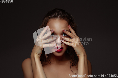 Image of Portrait of beautiful stylish woman isolated on dark studio background