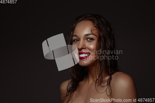 Image of Portrait of beautiful stylish woman isolated on dark studio background