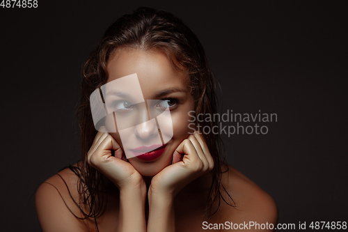 Image of Portrait of beautiful stylish woman isolated on dark studio background