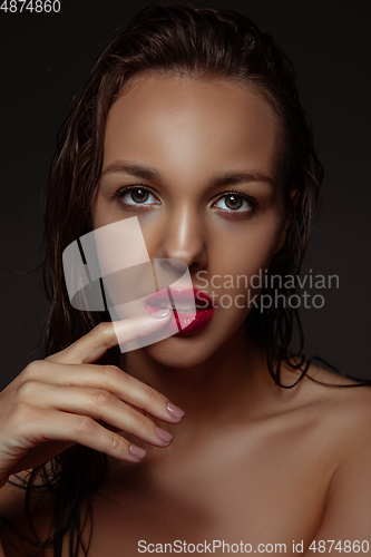 Image of Portrait of beautiful stylish woman isolated on dark studio background