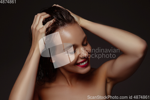 Image of Portrait of beautiful stylish woman isolated on dark studio background