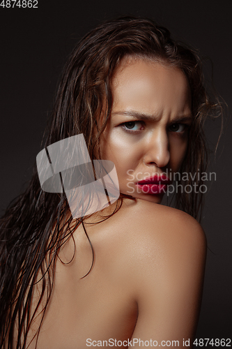 Image of Portrait of beautiful stylish woman isolated on dark studio background