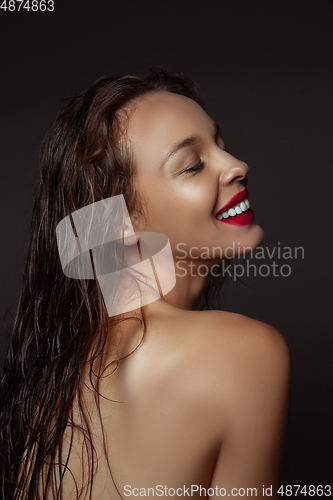 Image of Portrait of beautiful stylish woman isolated on dark studio background