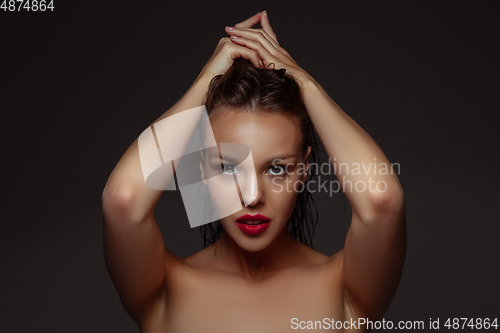 Image of Portrait of beautiful stylish woman isolated on dark studio background