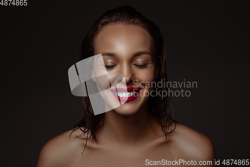 Image of Portrait of beautiful stylish woman isolated on dark studio background