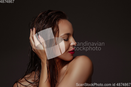 Image of Portrait of beautiful stylish woman isolated on dark studio background