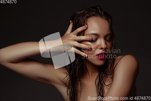 Image of Portrait of beautiful stylish woman isolated on dark studio background