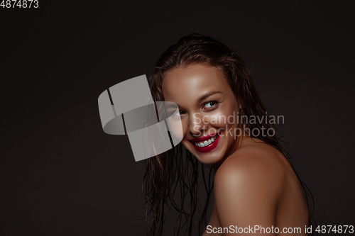 Image of Portrait of beautiful stylish woman isolated on dark studio background