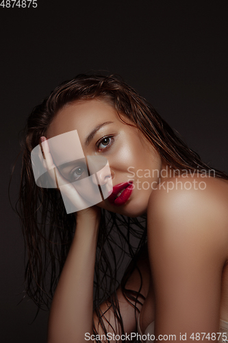 Image of Portrait of beautiful stylish woman isolated on dark studio background