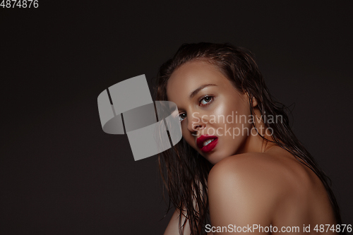Image of Portrait of beautiful stylish woman isolated on dark studio background