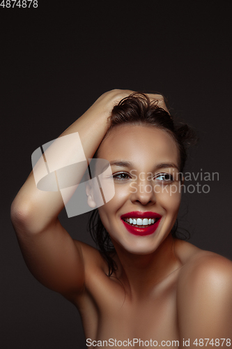 Image of Portrait of beautiful stylish woman isolated on dark studio background