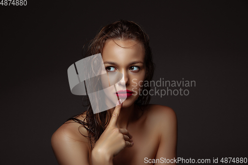 Image of Portrait of beautiful stylish woman isolated on dark studio background