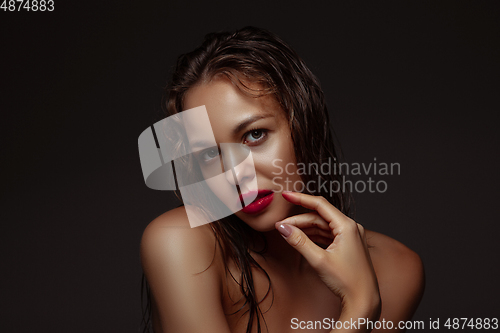 Image of Portrait of beautiful stylish woman isolated on dark studio background