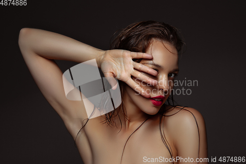 Image of Portrait of beautiful stylish woman isolated on dark studio background