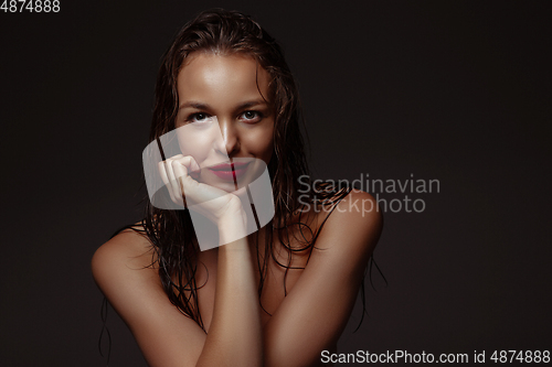 Image of Portrait of beautiful stylish woman isolated on dark studio background