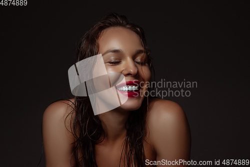 Image of Portrait of beautiful stylish woman isolated on dark studio background