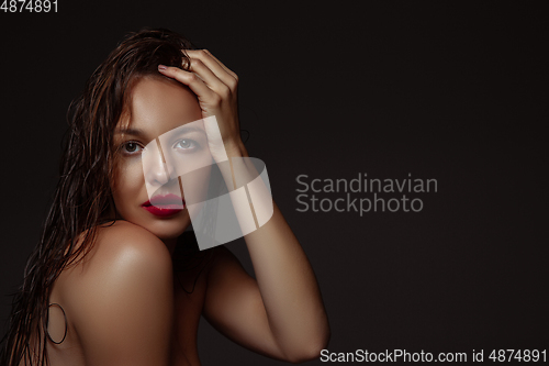 Image of Portrait of beautiful stylish woman isolated on dark studio background