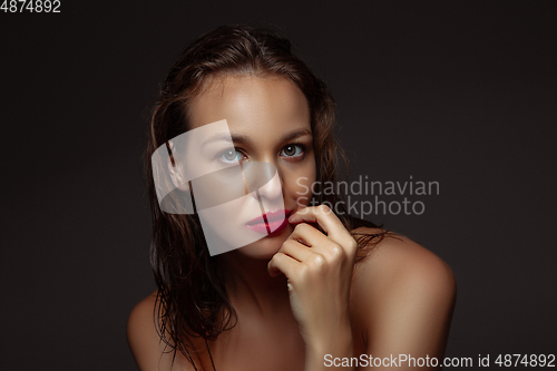 Image of Portrait of beautiful stylish woman isolated on dark studio background