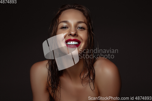 Image of Portrait of beautiful stylish woman isolated on dark studio background