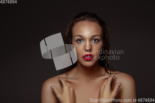 Image of Portrait of beautiful stylish woman isolated on dark studio background