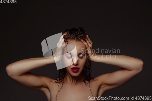Image of Portrait of beautiful stylish woman isolated on dark studio background