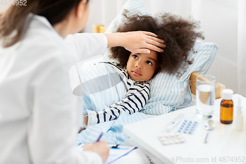 Image of doctor with clipboard and sick girl in bed at home