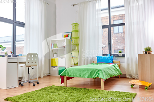 Image of kid's room interior with bed, table and bookcase