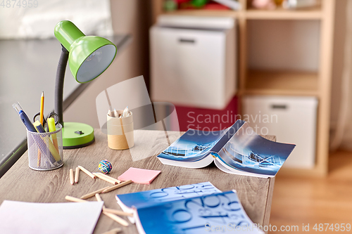 Image of school supplies scattered on table at home