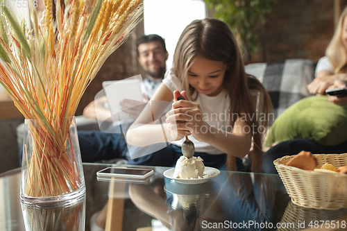 Image of Mother, father and daughter at home having fun, comfort and cozy concept