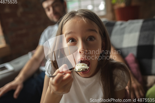 Image of Mother, father and daughter at home having fun, comfort and cozy concept