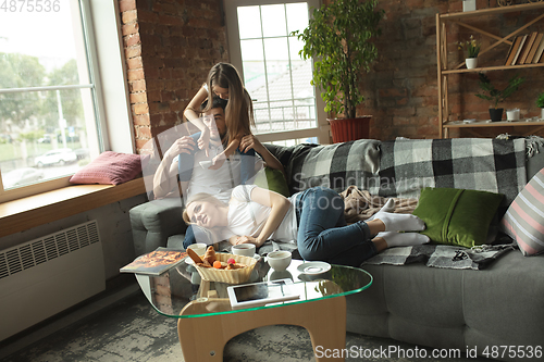 Image of Mother, father and daughter at home having fun, comfort and cozy concept