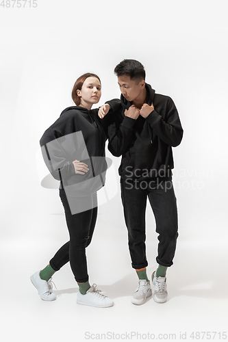 Image of Trendy fashionable couple isolated on white studio background