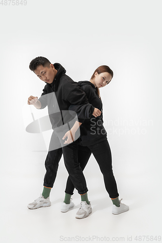 Image of Trendy fashionable couple isolated on white studio background