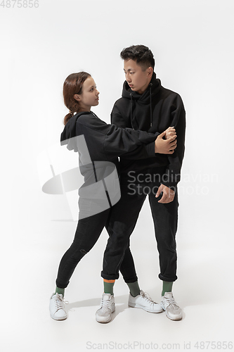 Image of Trendy fashionable couple isolated on white studio background