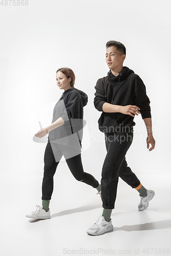 Image of Trendy fashionable couple isolated on white studio background