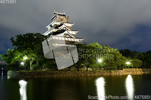 Image of Hiroshima castle on the side of Otagawa river at night