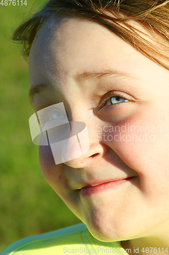 Image of portrait of little squinting girl with nice face