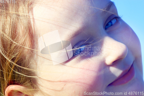 Image of portrait of little squinting girl with nice face