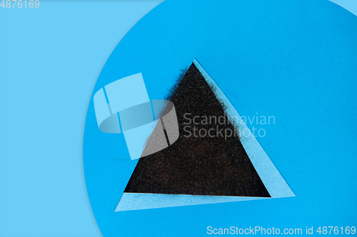 Image of Hair of african-american man peeking throught triangle in blue background