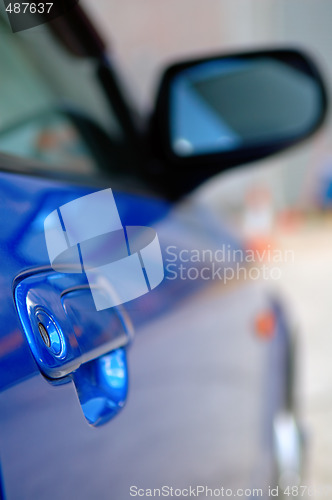 Image of Right side mirror of shiny blue car