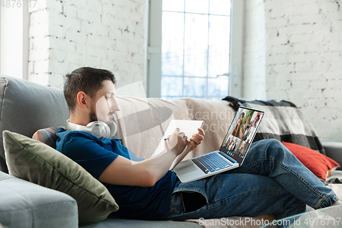 Image of Man participate video conference looking at laptop screen during virtual meeting, videocall webcam app for business, close up