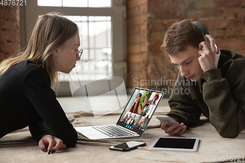 Image of Young man and woman participate video conference looking at laptop screen during virtual meeting, videocall webcam app for business, close up