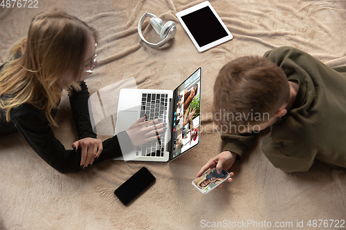 Image of Young man and woman participate video conference looking at laptop screen during virtual meeting, videocall webcam app for business, close up