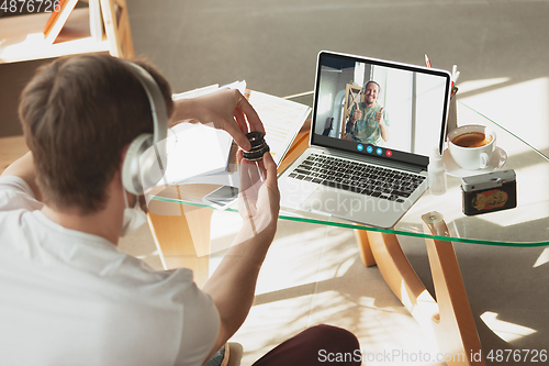 Image of Man participate video conference looking at laptop screen during virtual meeting, videocall webcam app for business, close up