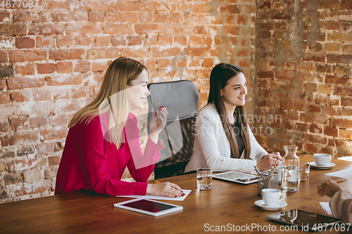 Image of Business young caucasian woman in modern office with team