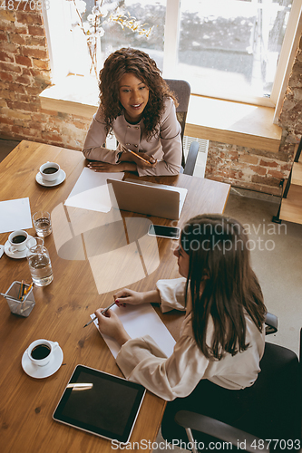 Image of Business young caucasian woman in modern office with team