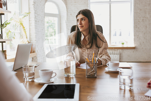 Image of Business young caucasian woman in modern office with team